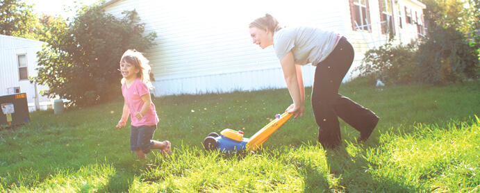 mother and daughter playing in the front yard