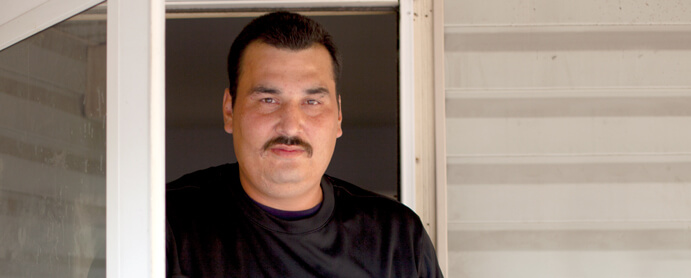 man standing in front door entryway