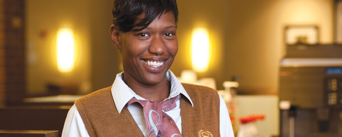 woman standing facing camera smiling