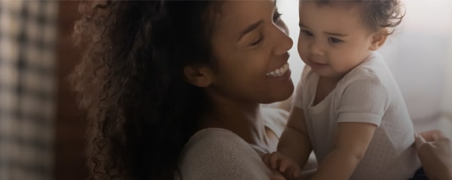 Smiling woman holding baby